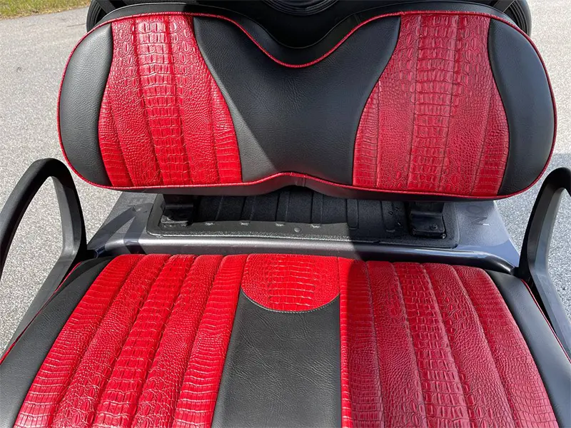 Technician servicing golf cart battery compartment